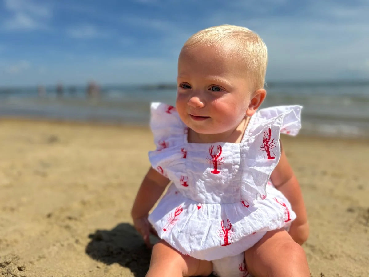 baby wearing outfit on the beach