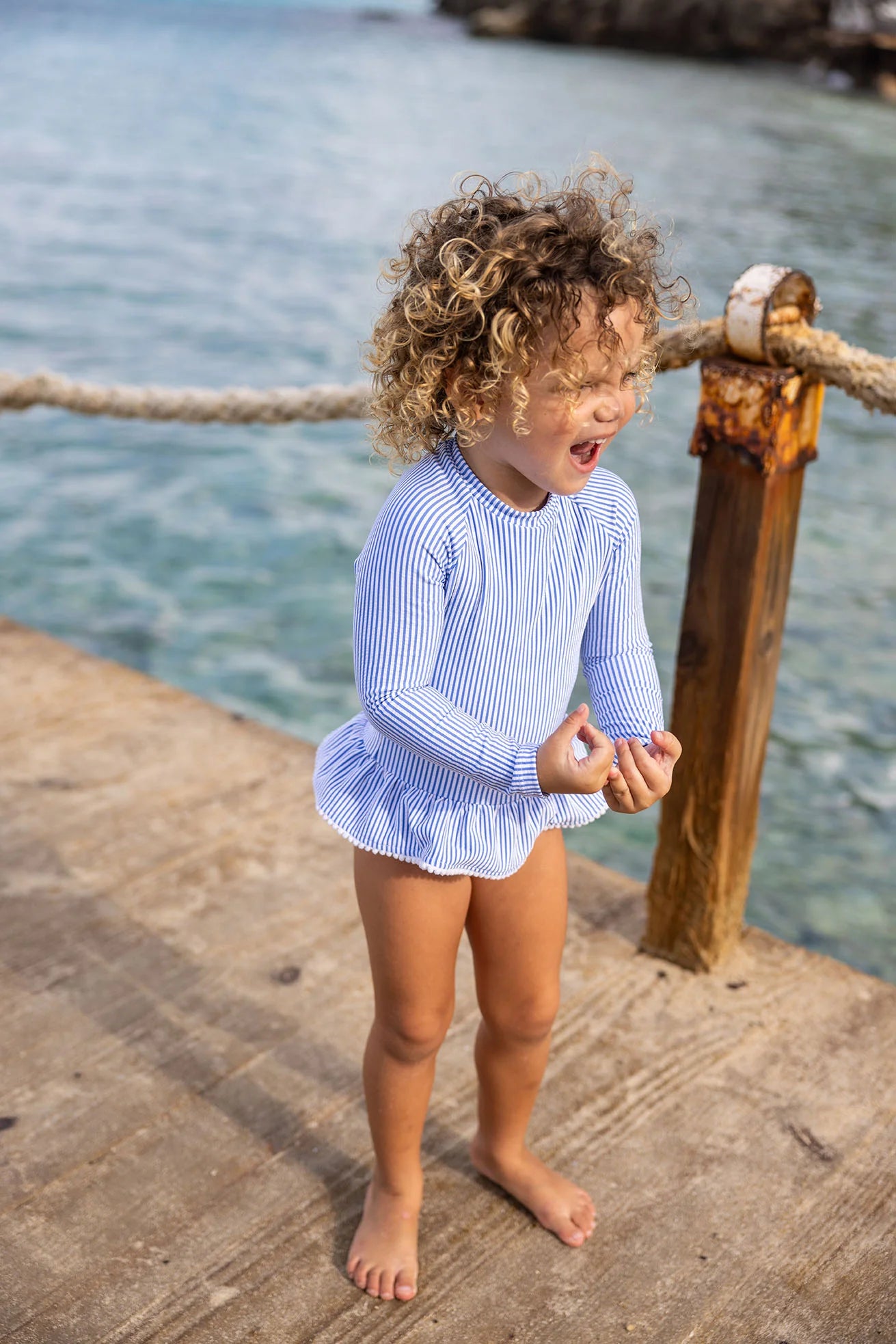 blue striped swimsuit with long sleeves and skirt
