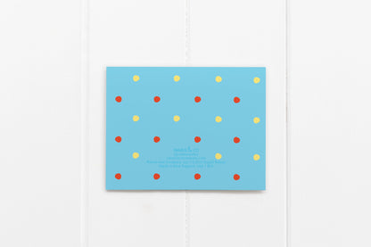 back of card has red and yellow polka dots