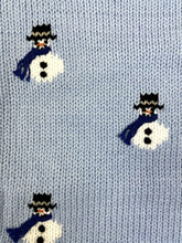 blue sweater with snowmen wearing hats and scarves all over