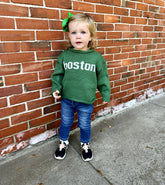 girl wearing sweater with jeans and sneakers