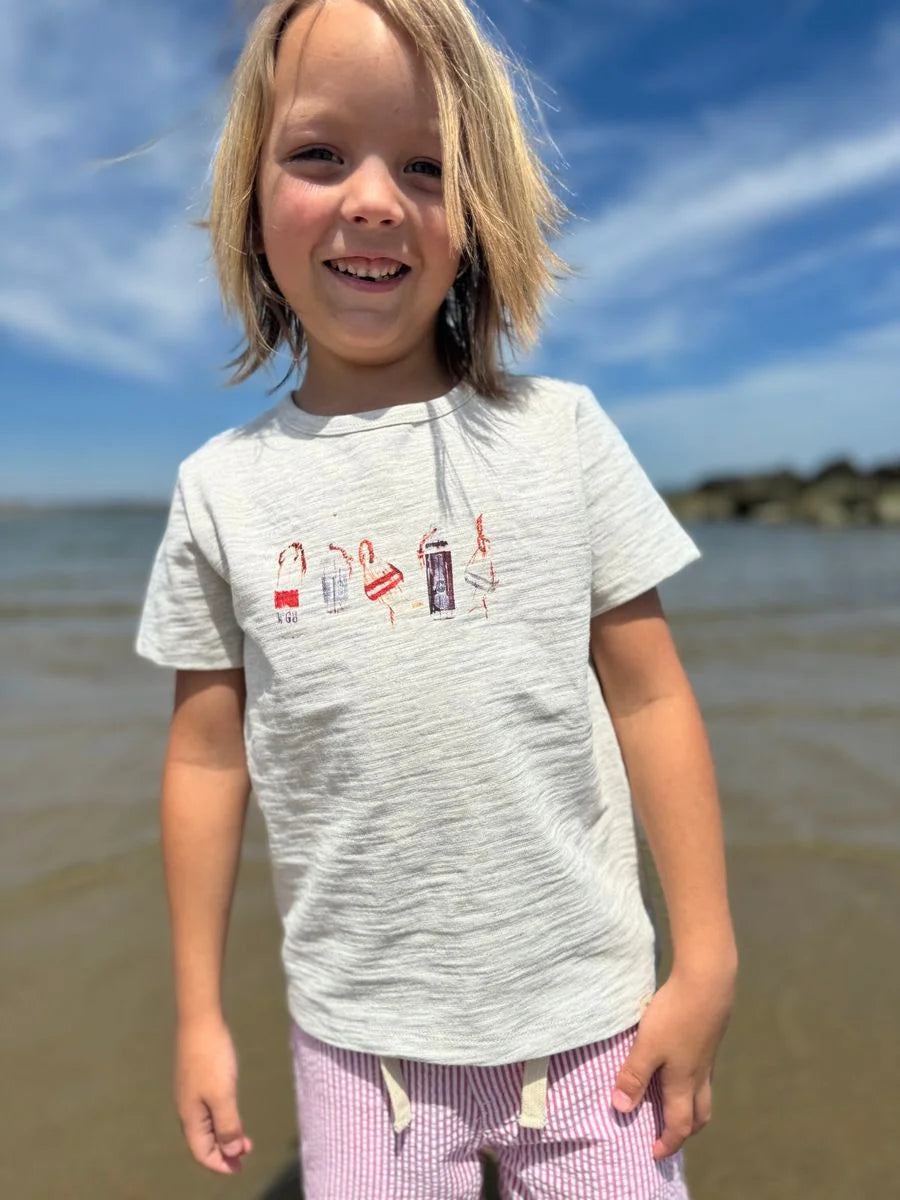 boy wearing buoy shirt on the beach