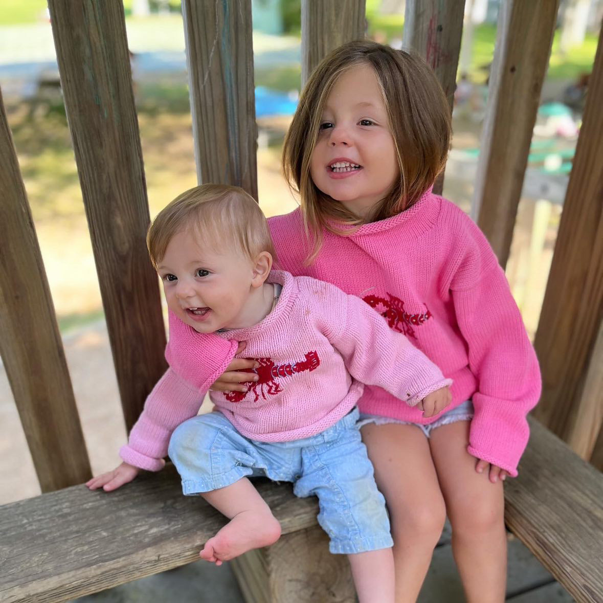 older girl is wearing Bright Pink Lobster sweater and baby is wearing Pink Lobster sweater