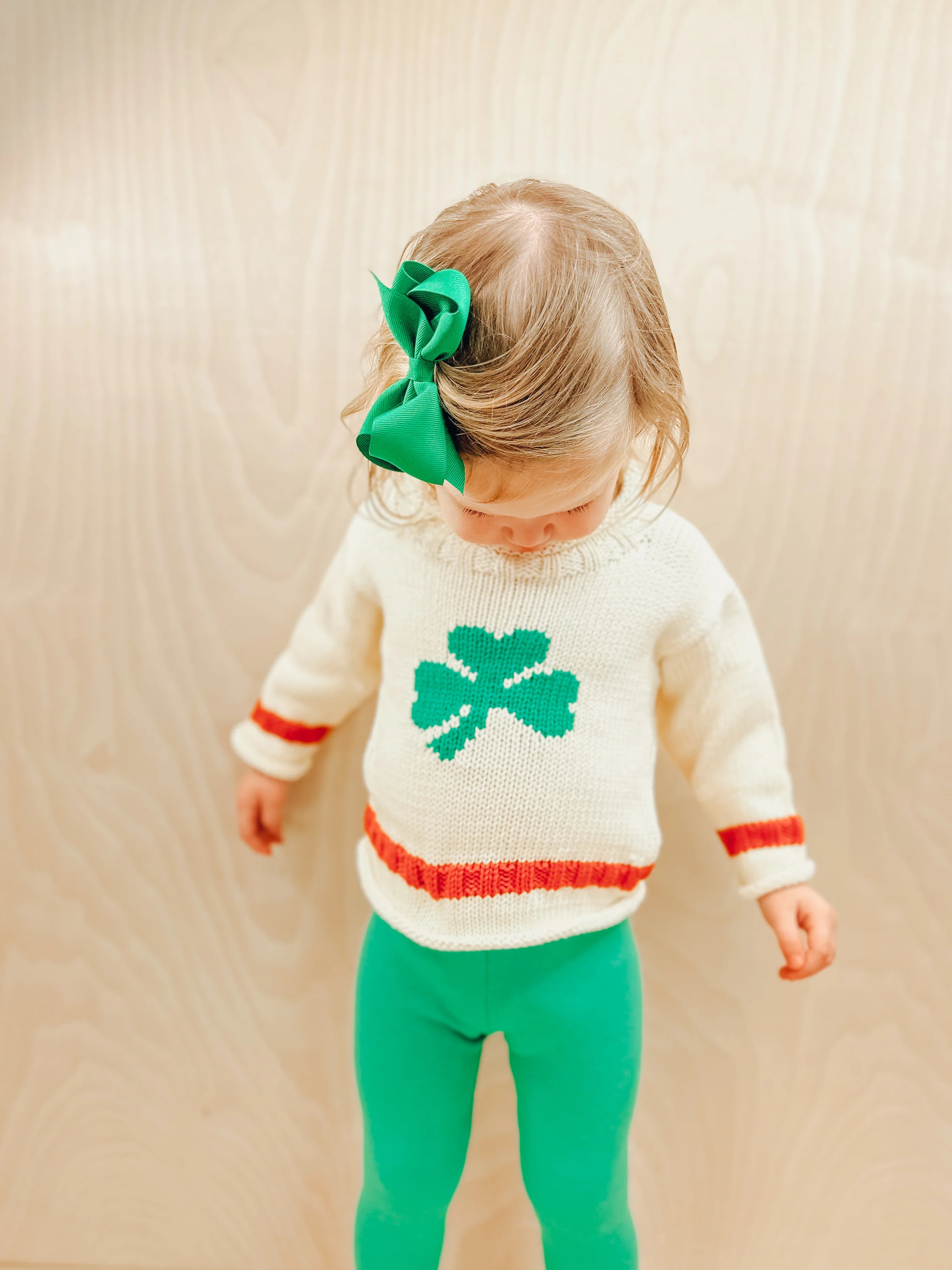 ivory shamrock sweater with orange stripe and green leggings