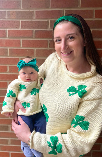 ivory roll neck sweater with green shamrocks knitted all over