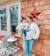 woman wearing ivory anchor rope sweater holding baby wearing the same sweater