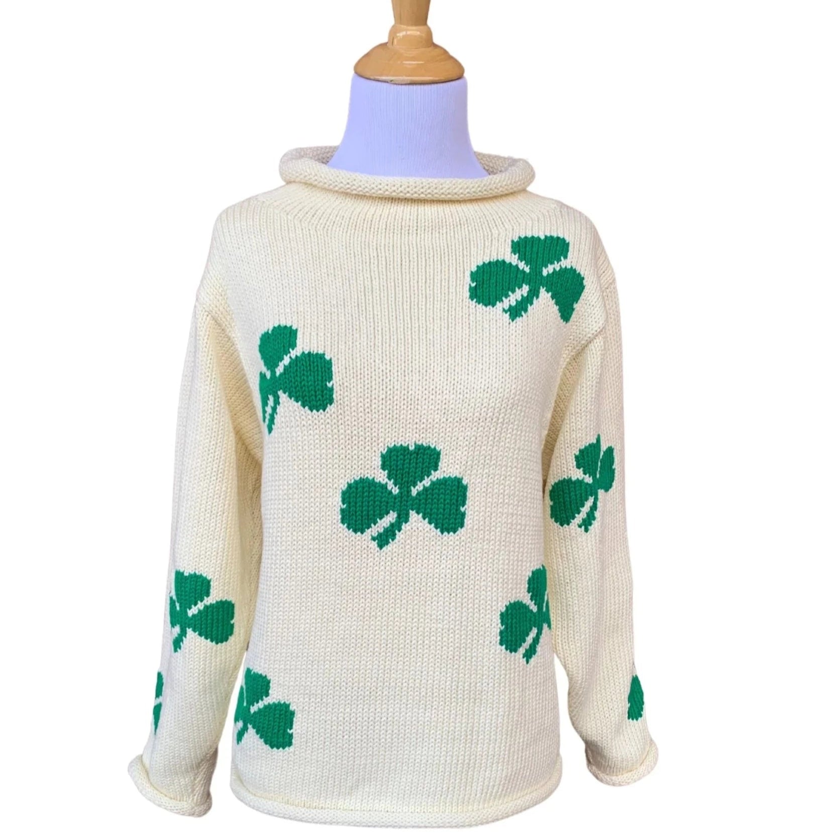 ivory roll neck sweater with green shamrocks knitted all over