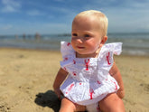 baby wearing outfit on the beach