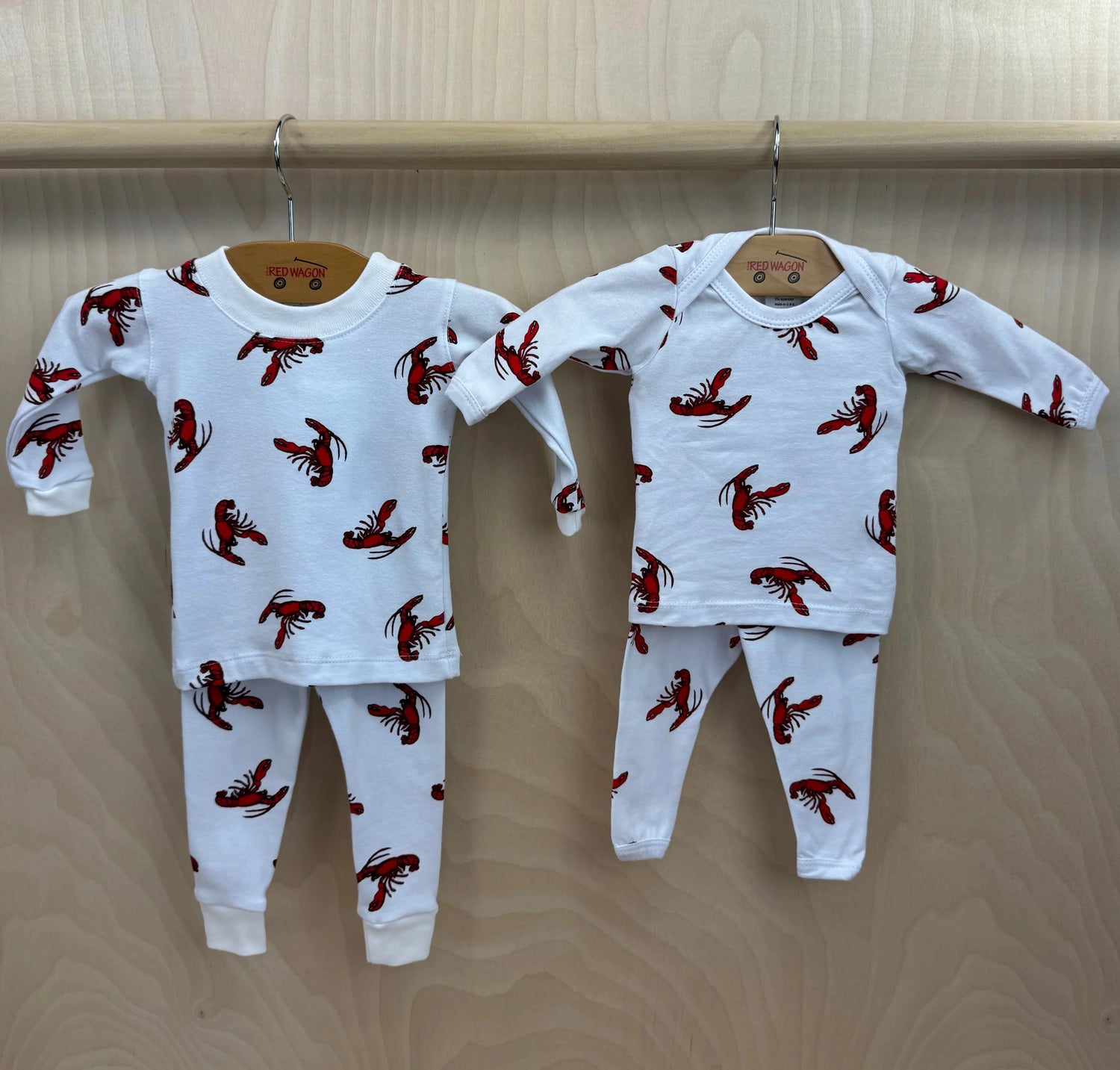 shows kids style on the left and baby style on the right of lobster pajamas