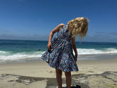 girl wearing buoy dress on beach