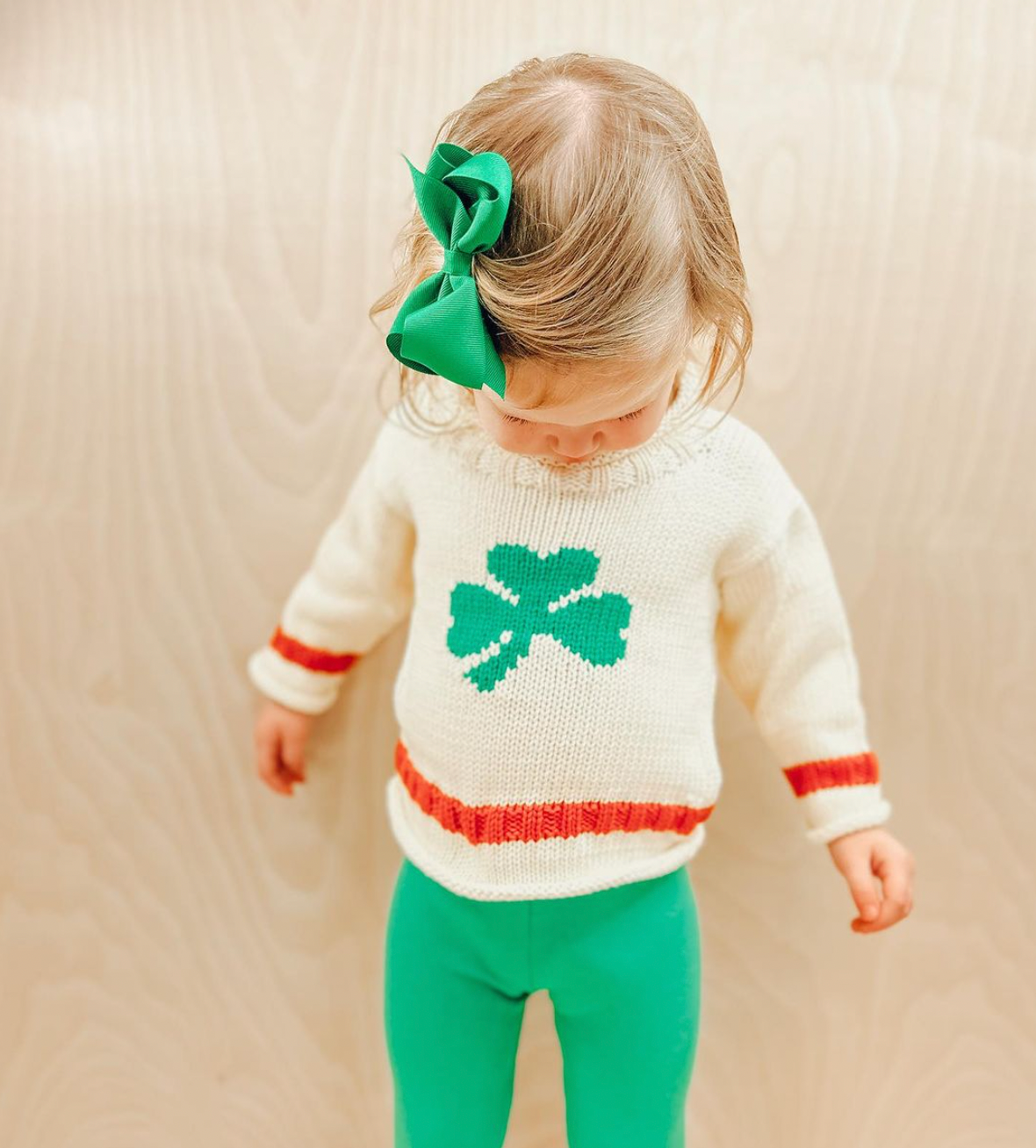 baby wearing shamrock sweater and kelly green leggings