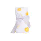 white swaddle blanket with yellow suns all over