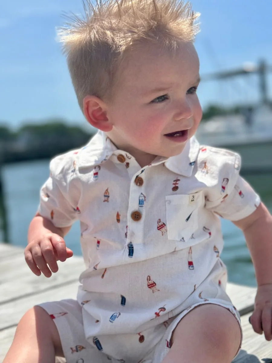 baby wearing buoy romper on dock