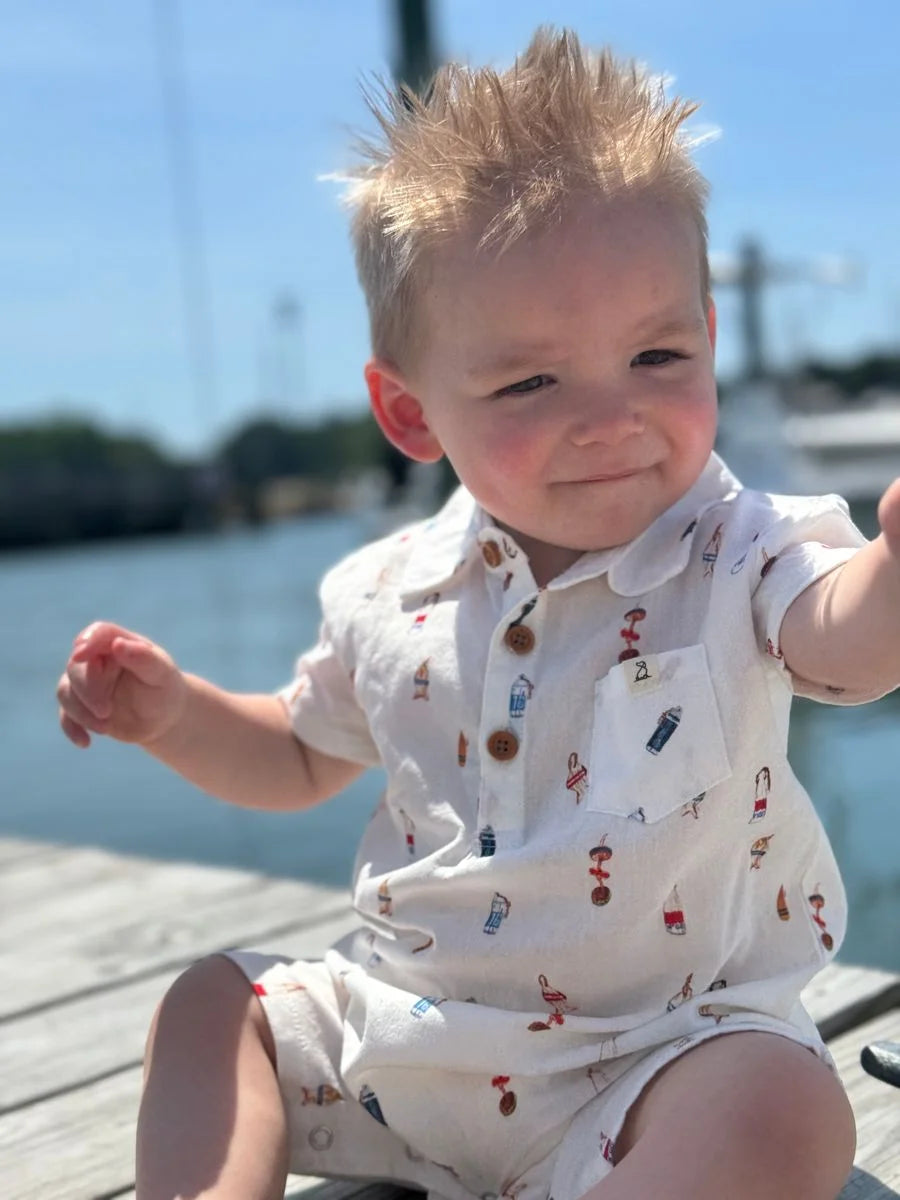 baby wearing buoy romper on dock