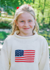 close up of little girl wearing sweater