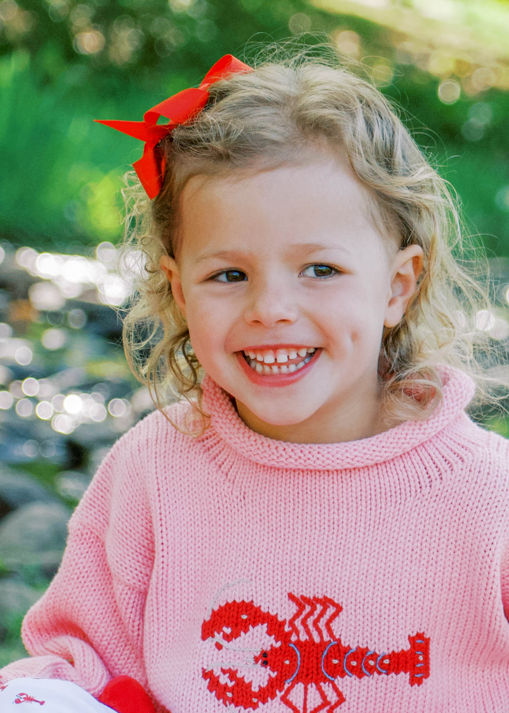 girl wearing pink lobster sweater