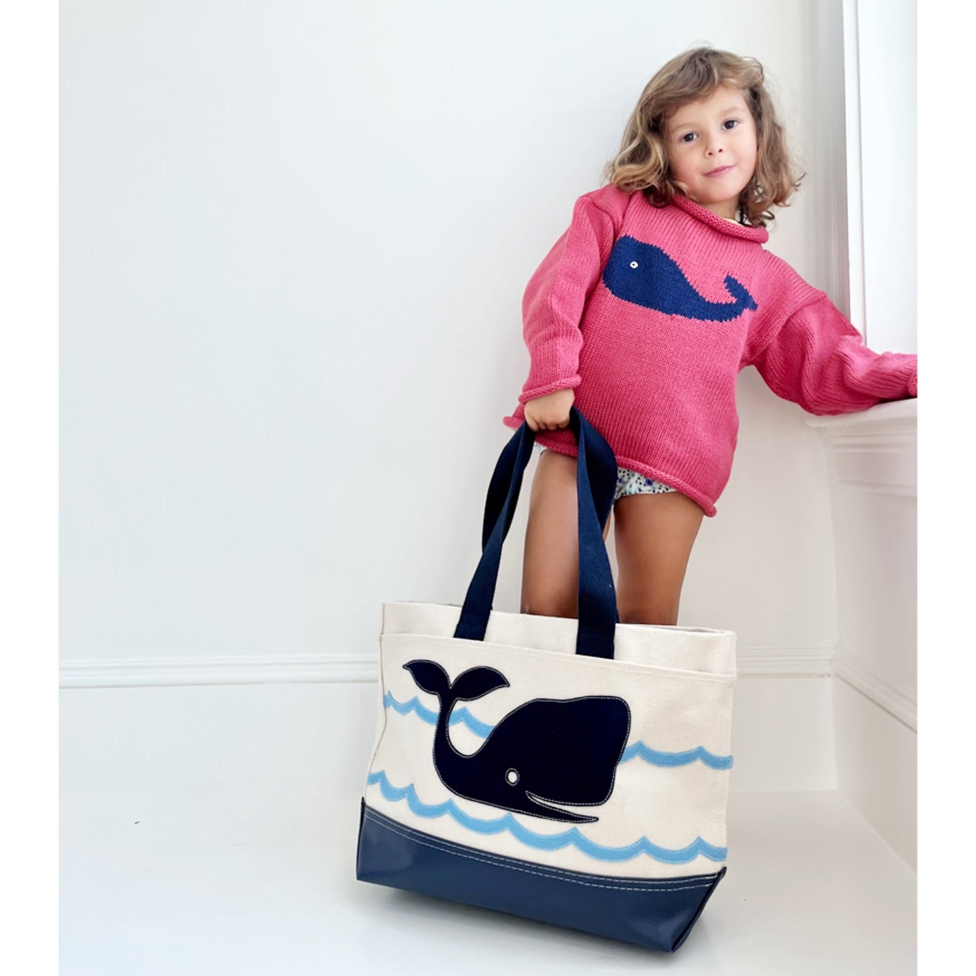 girl wearing sweater with tote bag