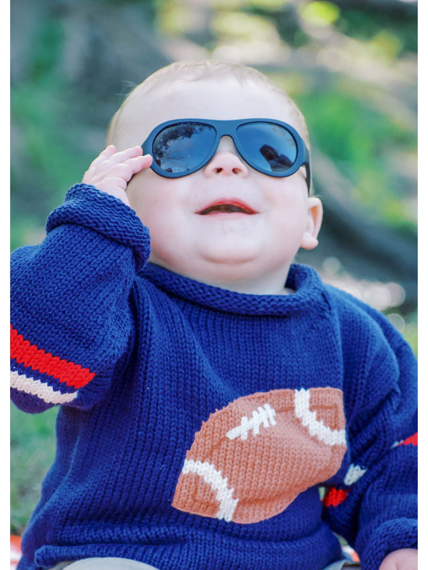 baby wearing navy football sweater