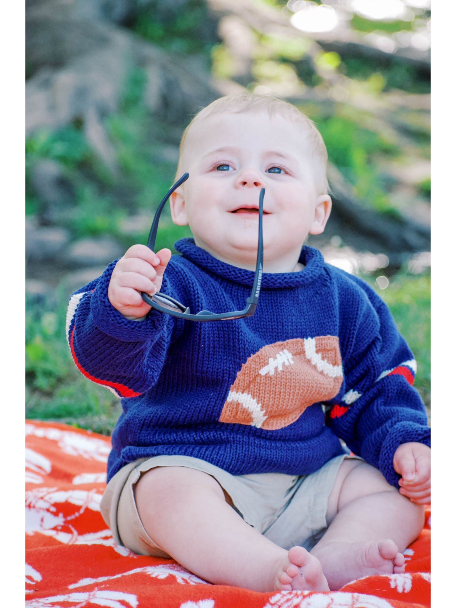 baby wearing navy football sweater