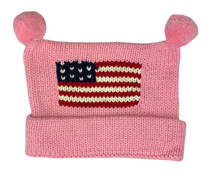 pink hat with bottom rolled up once and two pink poms at top and red white and blue american flag in center